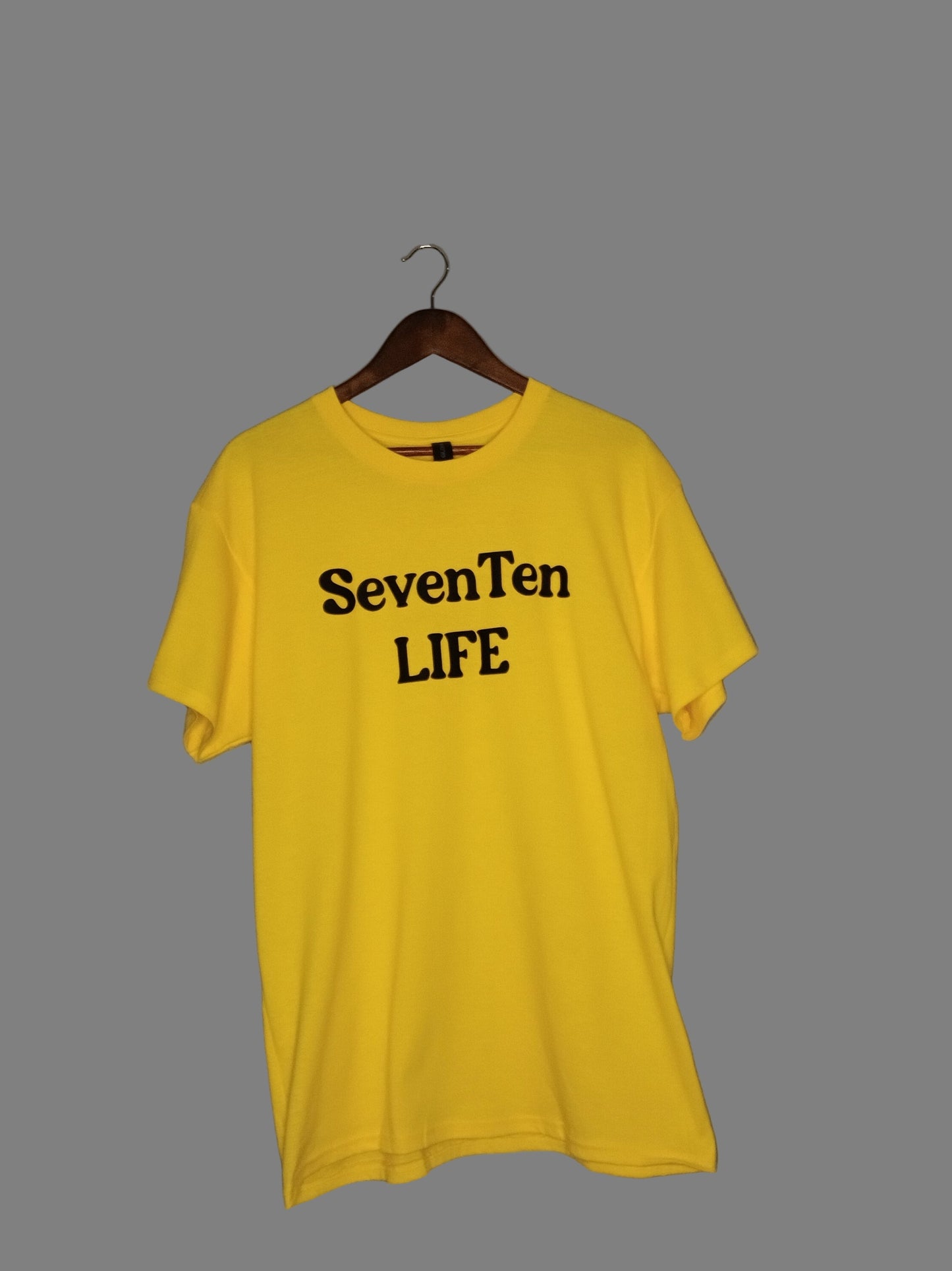 Yellow t-shirt with 'SevenTen LIFE' text on a gray background front view