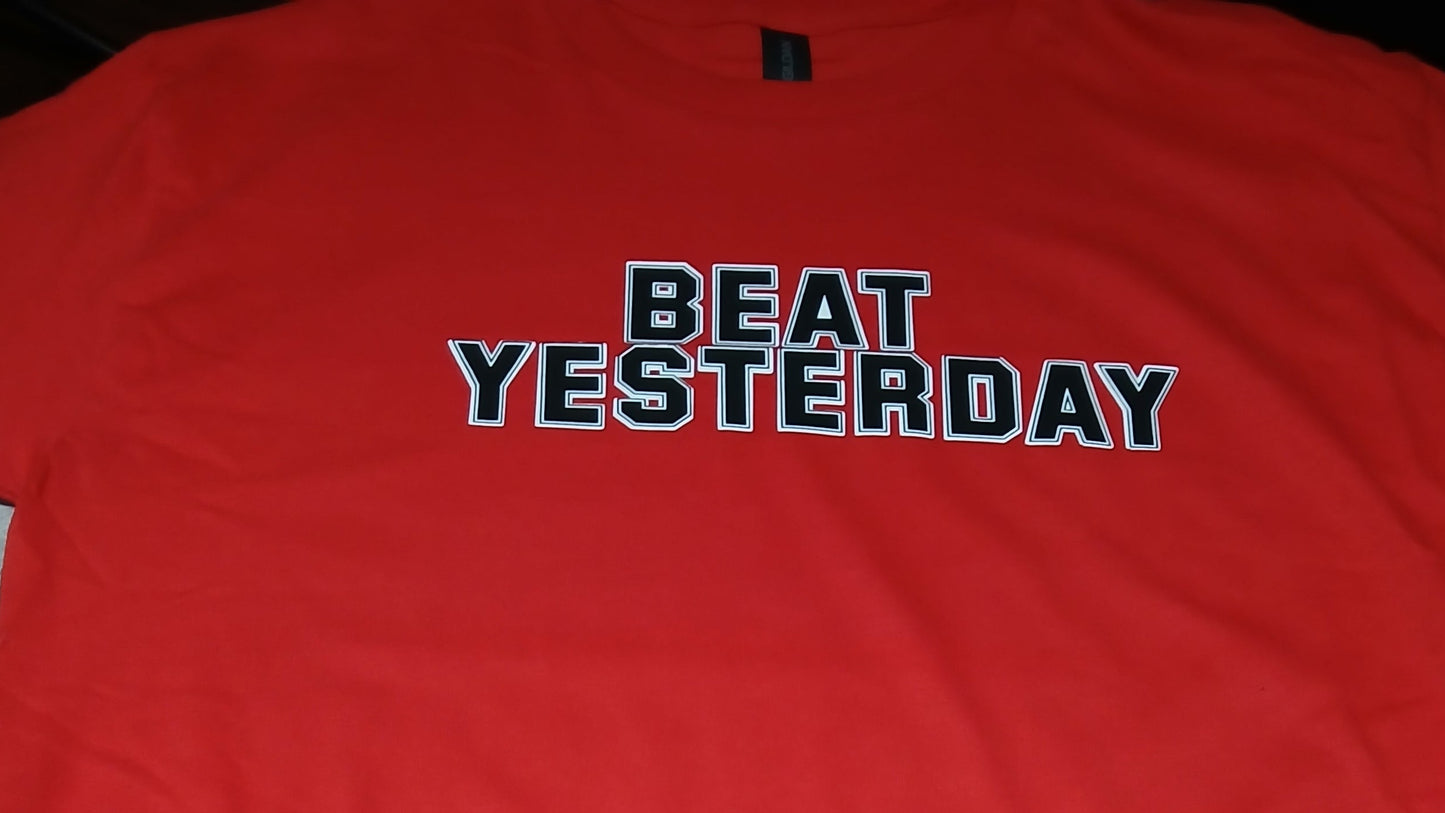 Red jacket with 'Beat Yesterday' text on a wooden surface