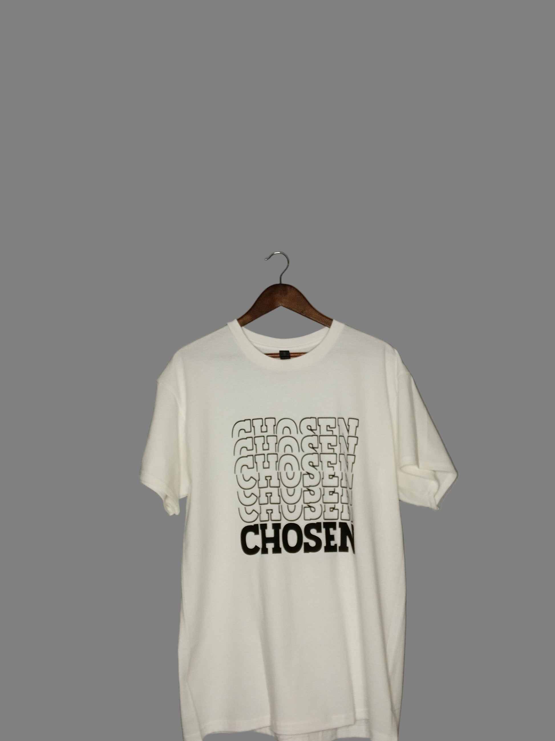 White t-shirt with 'CHOSEN' text on a hanger against a gray background