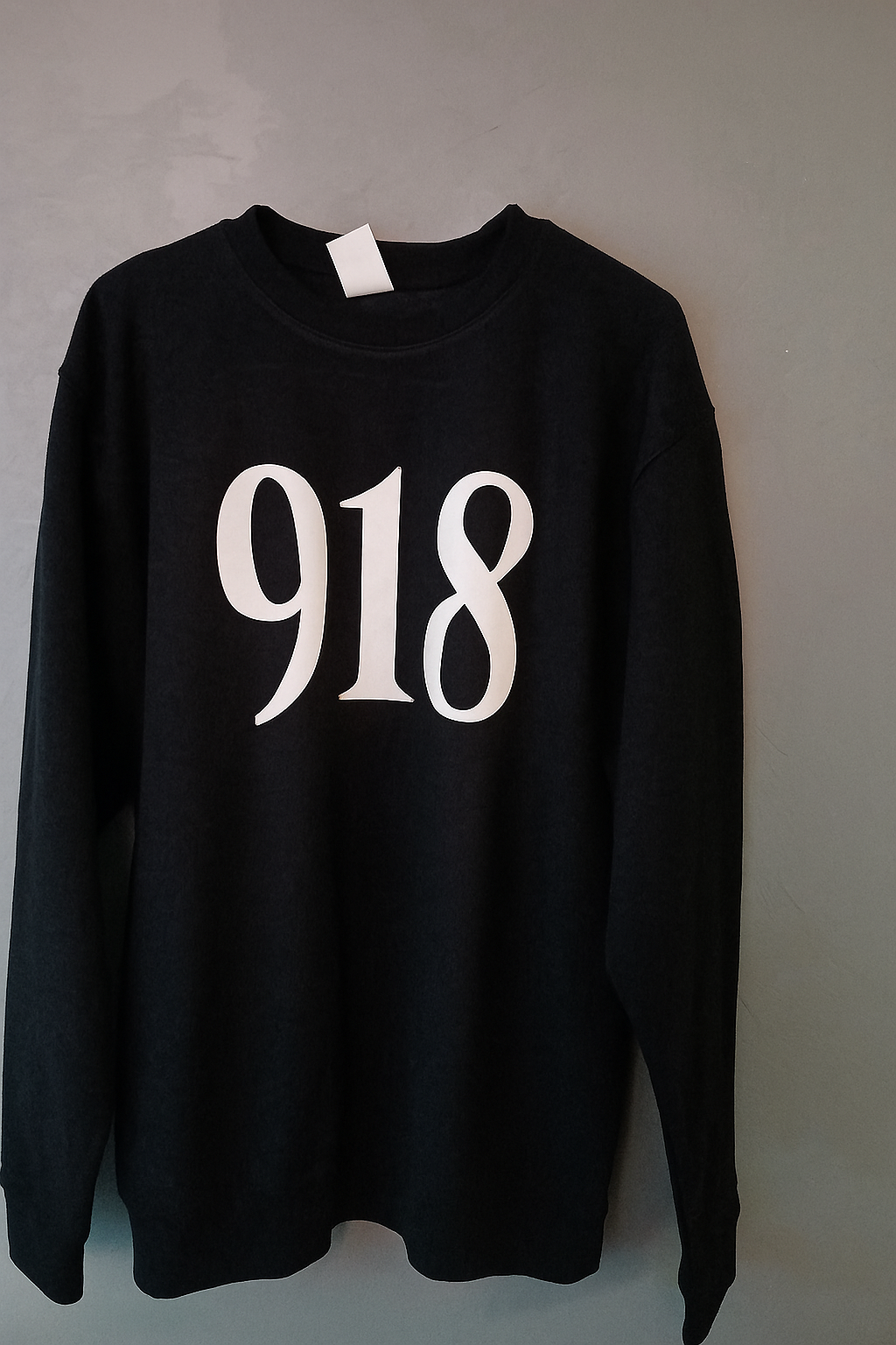 Black sweatshirt with '918' printed on it against a plain background